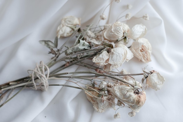 Soft fabric and dried flowers, Flowers on a bed, Rustic ribbon, Flowers tied with vintage rope