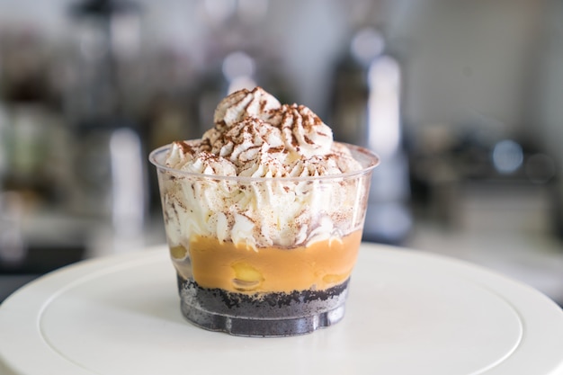 Photo soft focus of banoffee cups  on cake decorating turntable in coffee shop