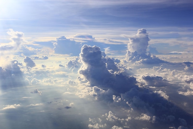 Soft focus of beautiful cloud and blue sky with sunset light from airplane window