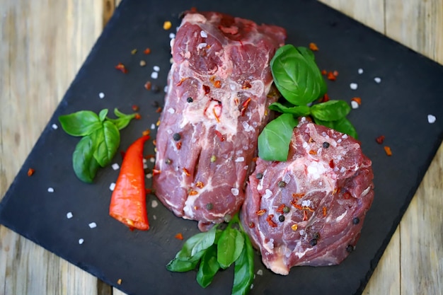 Soft focus Pieces of raw lamb with spices on the board Lamb marinade