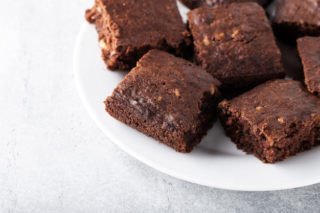 Soft focus zucchini brownies with walnuts on a plate