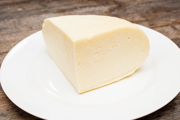 soft goat cheese in a bowl on a wooden table