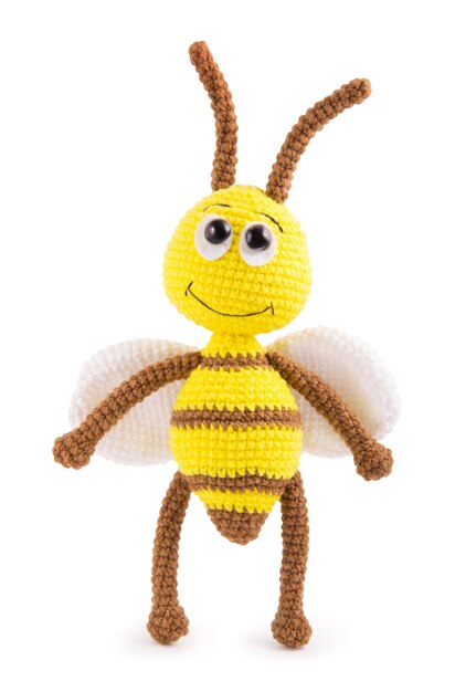 Soft knitted toy bee on a white