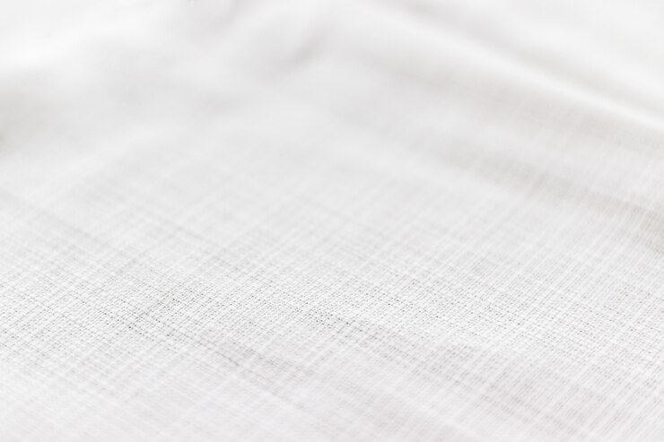 Soft light gray natural linen texture with focus at the bottom. Crumpled fabric background. Selective focus. Closeup view