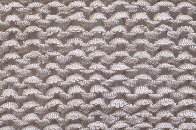 Soft light natural texture of knitted wool textile material background White crochet cotton fabric woven canvas