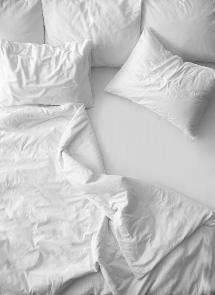 Photo soft pillows on comfortable bed top view