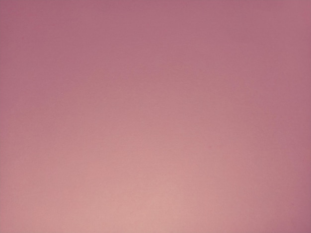 Soft pink background. A sheet of paper with different lighting. Blush shade. Can be used as a background or as a sample of cosmetics for face, blush or lipstick.