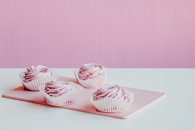 Soft pink marshmallows on the table background