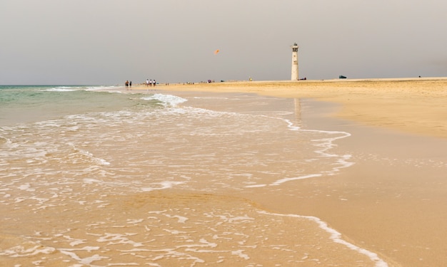 Soft sea wave on the golden sand of Morro Jable beach, Fuerteventura.