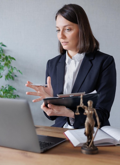 Soft selective focus female lawyer conducts an online consultation from a laptop via video link for