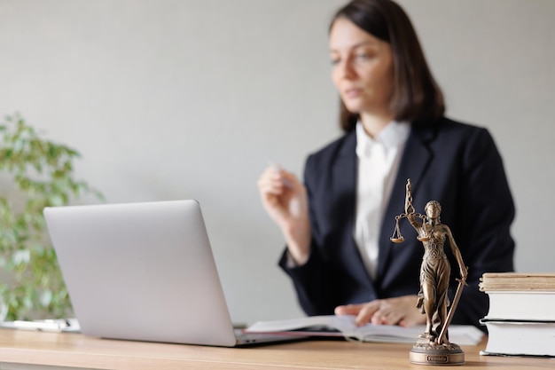 Soft selective focus female lawyer conducts an online consultation from a laptop via video link for