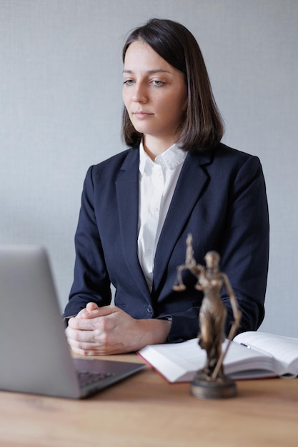 Soft selective focus female lawyer conducts an online consultation from a laptop via video link for