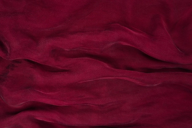 Soft smooth burgundy silk fabric background Fabric texture