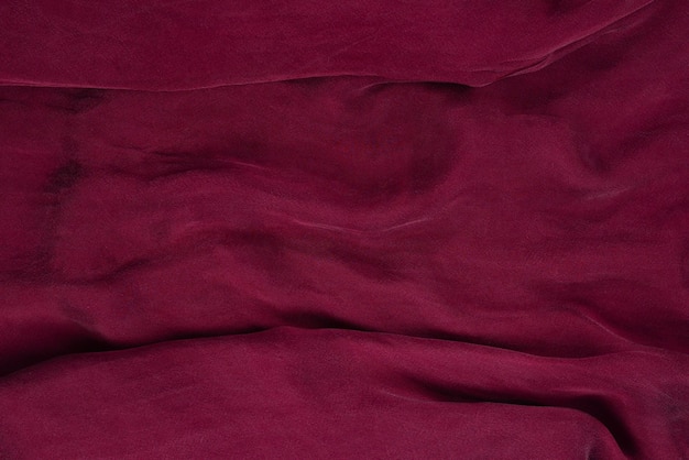 Photo soft smooth burgundy silk fabric background fabric texture