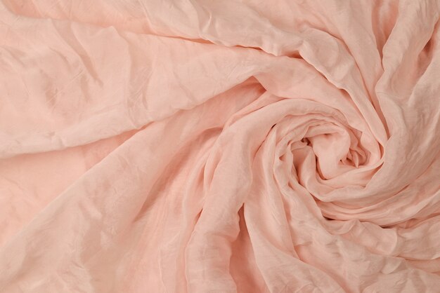 Sfondo morbido tessuto di seta rosa liscio. trama del tessuto.