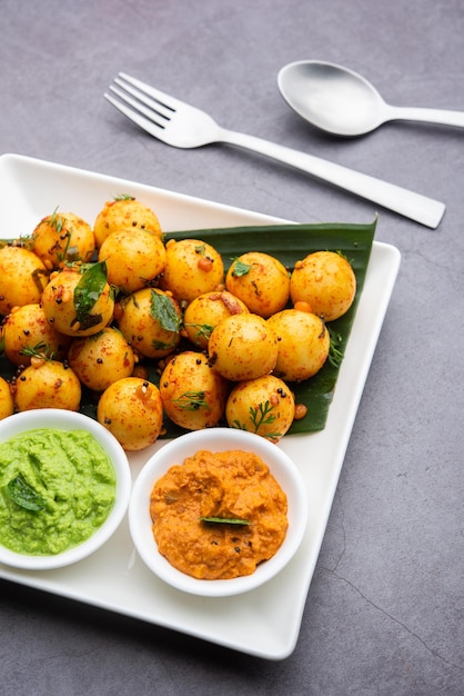 Soft and spongy Idli balls or goli idly with green and red chutney south indian food recipe