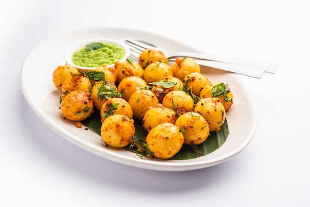 Soft and spongy Idli balls or goli idly with green and red chutney south indian food recipe