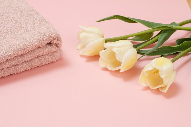 Soft terry towels with flowers on a pink background