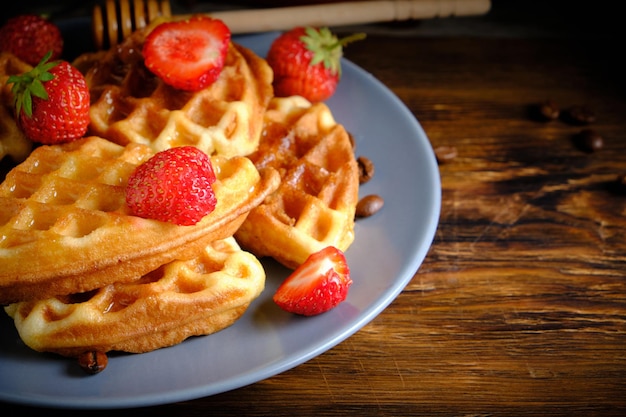 Soft waffles strawberries and poured with honey