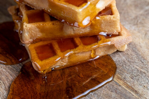 Soft waffles with natural bee honey on a serving board