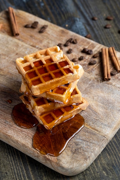 Soft waffles with natural bee honey on a serving board