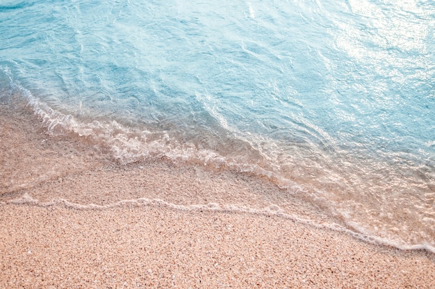 Soft wave of blue ocean on sandy beach