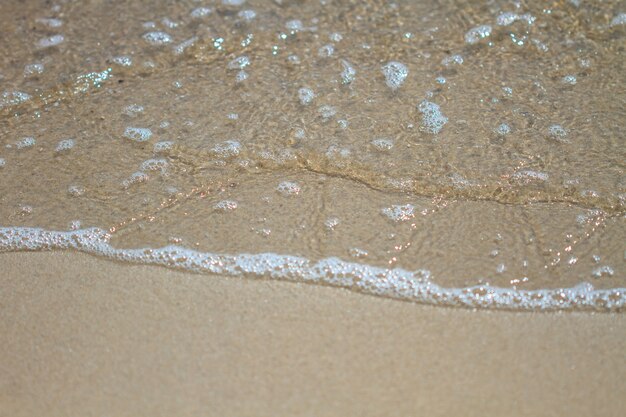 Photo soft wave on the sandy beach