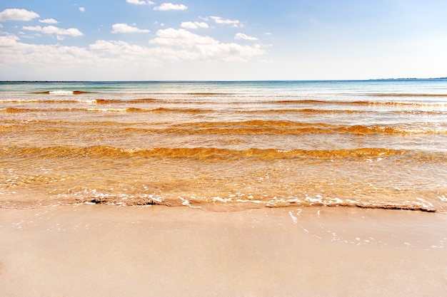 Soft wave of the sea on the sandy beach. Blue sky, golden sand and place for text. Varadero, Cuba, Caribbean sea.