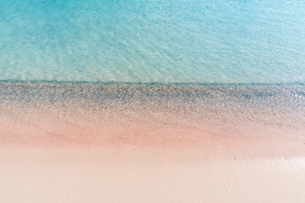 Soft waves of the sea on the pink sand and beautiful beach