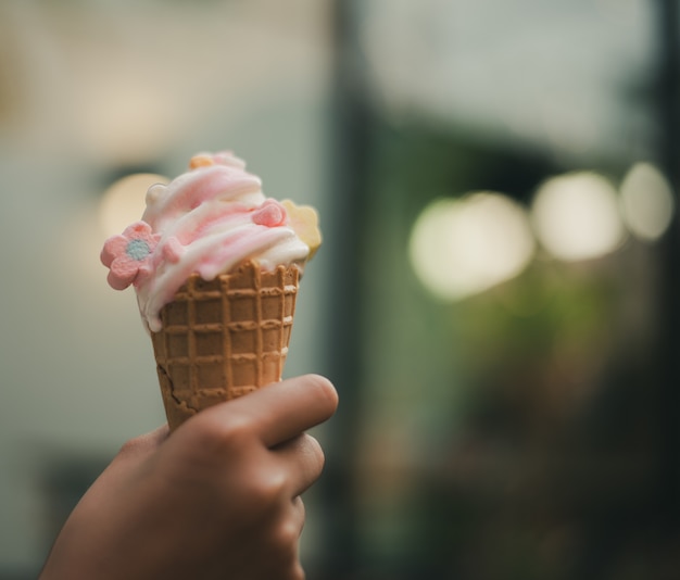 Soft white milk cream ice cream cone serve in hot summer day on sky with sun lighting 