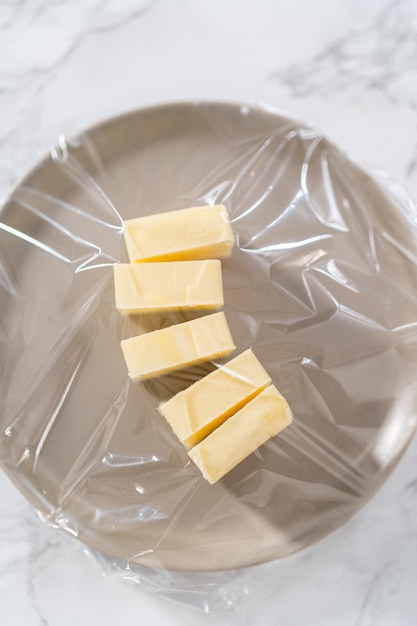 Softened sticks of unsalted butter on the kitchen counter