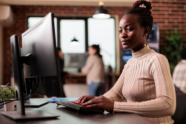 Software developer brainstorming ideas to write code and create new interface in data room. Tech enginner sitting at desk programming server database, working in busy it agency.