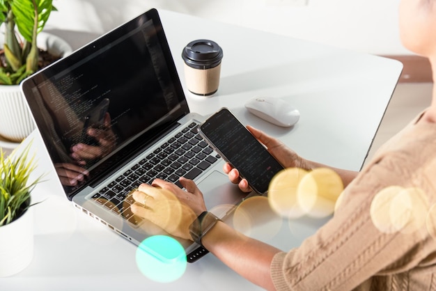 Software developer hands typing data coding programming\
javascript with laptop computer