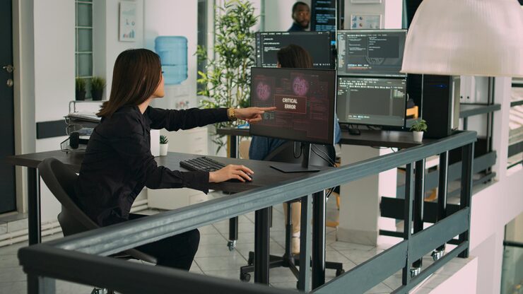 Photo software developers dealing with hacked online system, looking at critical error on computer. coders saving database and programming information on network, it development agency.