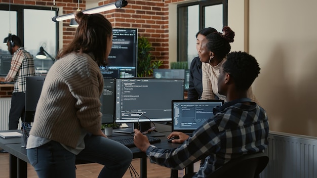 Software developers discussing about cloud programming\
innovation while the rest of the team joins the discussion.\
programmers doing teamwork computing big data in server room.