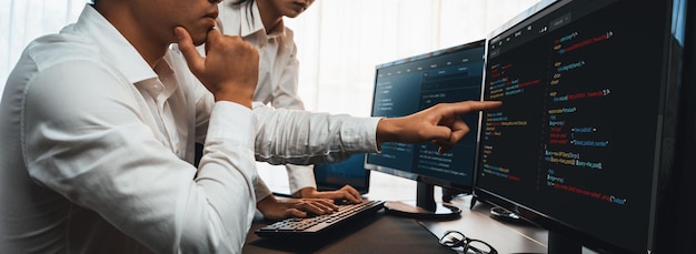 Software development team working together in office coding script display on computer monitor Programmer and software engineer working in tech developer company Trailblazing