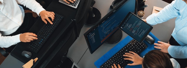 Software development team working together in office coding script display on computer monitor Programmer and software engineer working in tech developer company Trailblazing