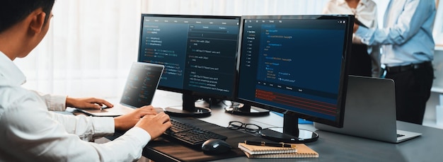 Software development team working together in office coding script display on computer monitor Programmer and software engineer working in tech developer company Trailblazing