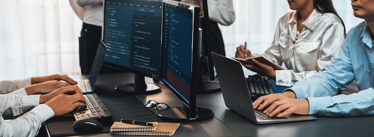 Photo software development team working together in office coding script display on computer monitor programmer and software engineer working in tech developer company trailblazing