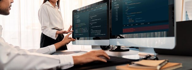 Software development team working together in office coding script display on computer monitor Programmer and software engineer working in tech developer company Trailblazing