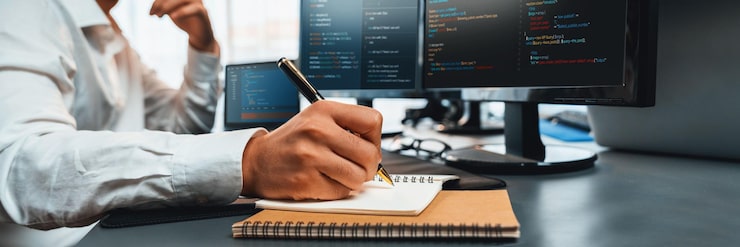 Photo software engineer working on application development on his computer display code and script on monitor at tech company office workplace application developer solving and writing code trailblazing