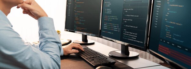 Software engineer working on application development on his computer display code and script on monitor at tech company office workplace Application developer solving and writing code Trailblazing