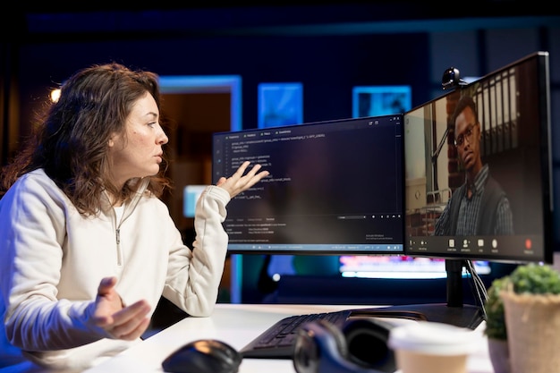 Software technician teacher doing online tutoring talking with student