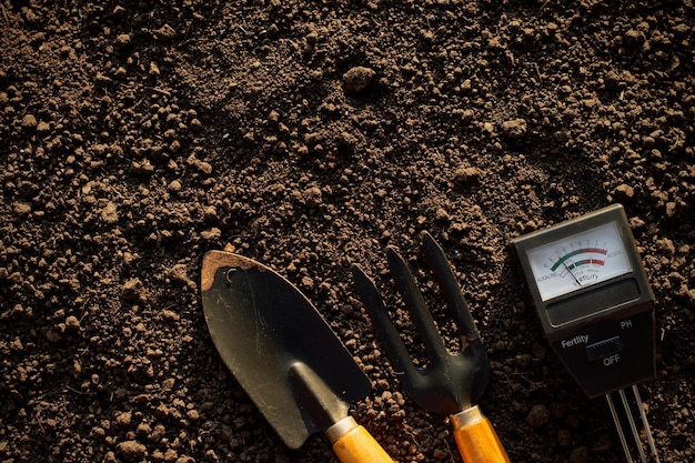 Soil meters and farming equipment are placed on the soil for cultivation.