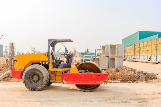 Soil vibration roller during sand compacting works at construction site