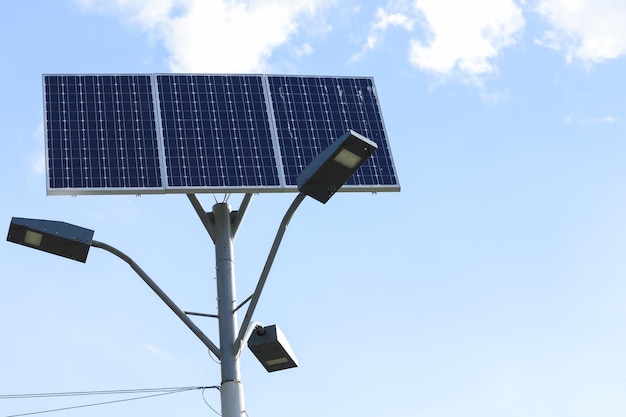 Solar cell lamp on sky background Light support with lantern and installed solar panels on blue sky