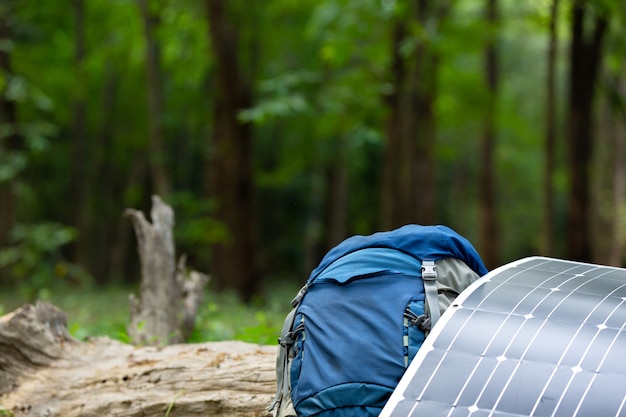 Photo solar cell with backpack color blue in the forest