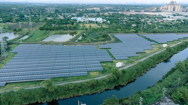 Solar cells farming beside with rivers and factories in industrial area