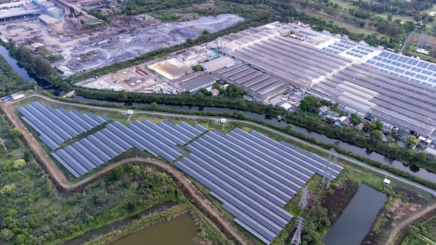 Solar cells farming beside with rivers and factories in industrial area
