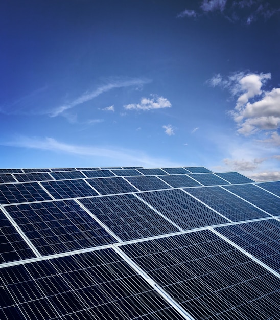 Photo solar energy power plant over a beautiful cloudy sky. space for text.